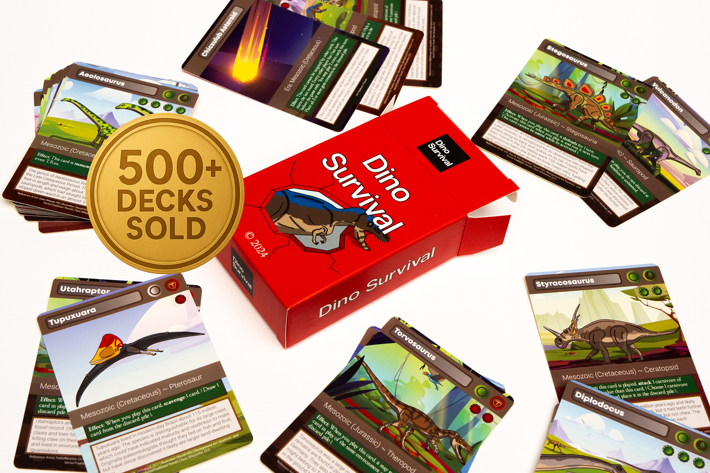 Dino Survival card game box surrounded by cards on a white background. Over 500 Decks sold.